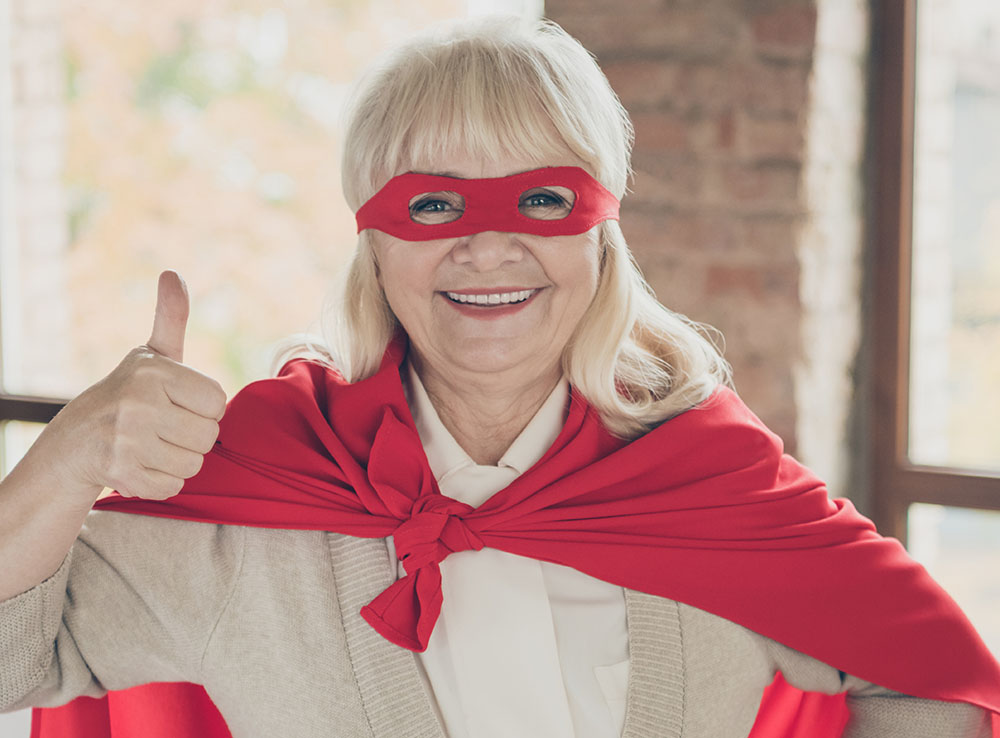 thumbs up masked older woman